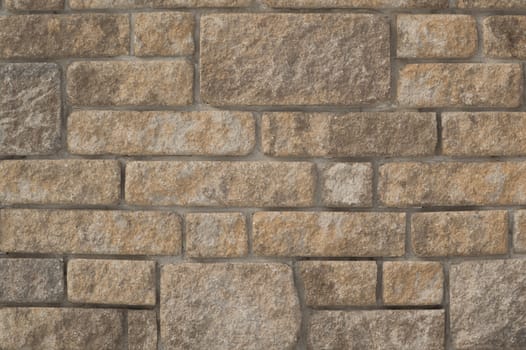 Rugged limestone wall filled with cement mortar.