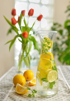 Fresh limes and lemonade on table