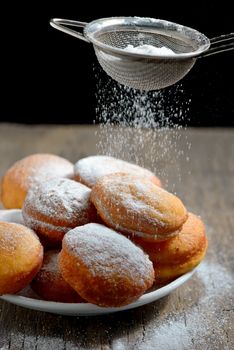 Donuts with powdered sugar on table