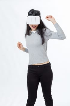 Teenage girl wearing 3D  VR goggles, dancing and smiling