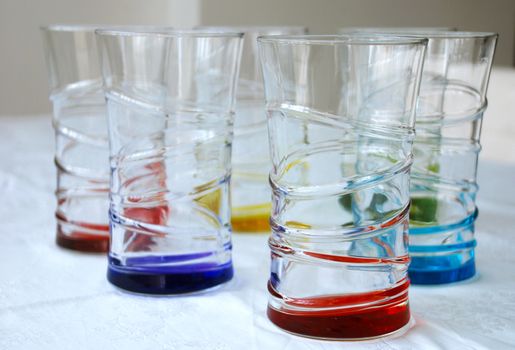 six brightly colored beverage glasses