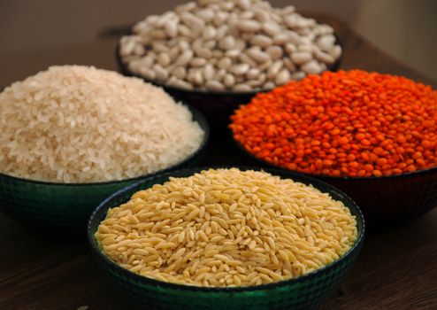 in a glass bowl of rice, red lentils, haricot beans and barley noodles