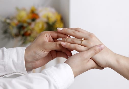 Bride wears a wedding ring to the groom