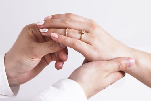 Bride wears a wedding ring to the groom