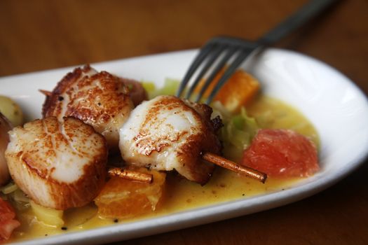 Close up Scallop seafood appetizer with with oranges and grapefruits