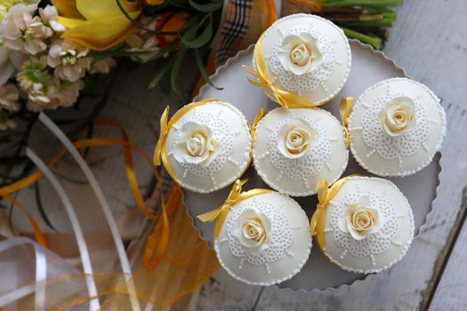 Beautiful cakes and bridal bouquet in orange tones
