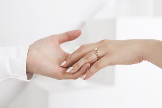 Bride wears a wedding ring to the groom