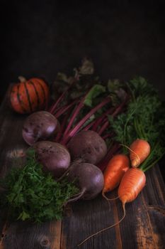 Fresh vegetables and pumpkin against the background of old boards