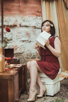 retro girl sitting at a dressing table with a letter in your hands