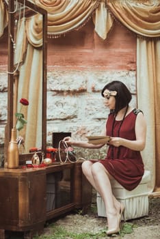 retro girl sitting at a dressing table with a letter in your hands