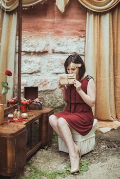 retro girl sitting at a dressing table with a letter in your hands