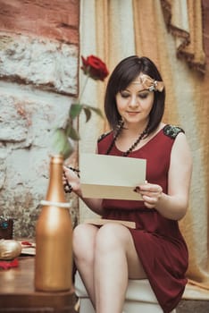 retro girl sitting at a dressing table with a letter in your hands