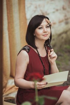 Portrait of a girl in a retro style that sits with letter in your hands