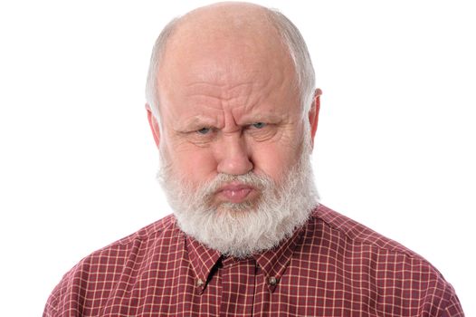 Handsome bald and bearded senior man shows resentful facial expression, isolated on white background