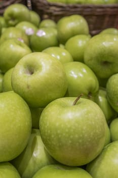 Group of green apples in a basket
