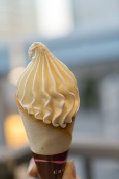 hand holding a creamy ice cream cone