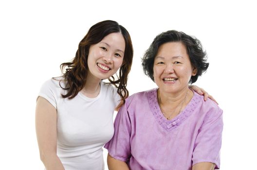 Portrait of Asian senior mother and adult daughter smiling and looking at camera, isolated on white background.