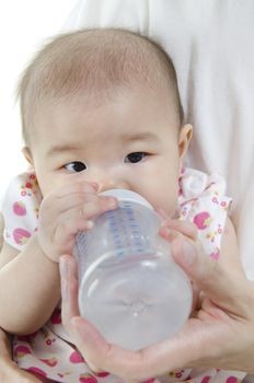 Asian father feeding baby girl drinking milk bottle.