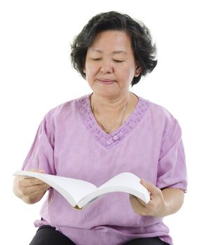 Wisdom 60s Asian senior adult woman reading book, isolated on white background.