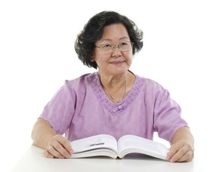 Wisdom Asian senior adult woman reading book, isolated on white background.