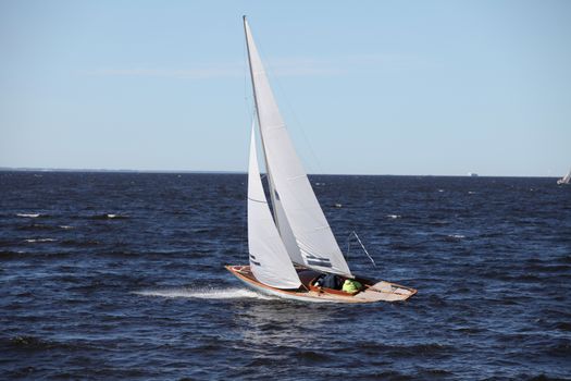 classic yacht with white sails in the sea in motion