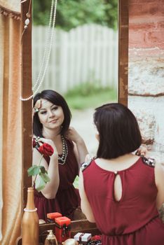 retro girl sitting at a dressing table, looking in mirror