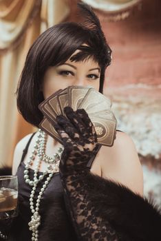 Women's hands in retro style with playing cards in hands