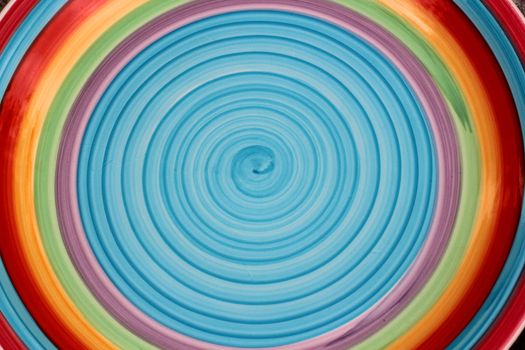 Brightly colored circular background (blue, yellow, red)