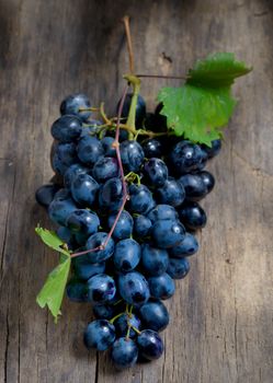 Bunch of red grapes on wooden table background