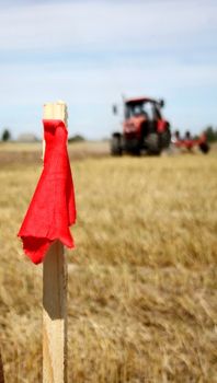 the red signal flag on the edge of the field to guide the mechanic