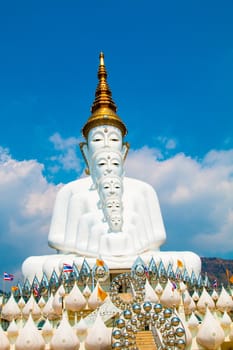 Phetchabun, Thailand - February 23.2017: Buddha statues and colored foot path colorful glass stacked in Wat Pha Kaew, Khao Kho, Phetchabun on February 23.2017 at Thailand.There. A famous Buddhist temple.