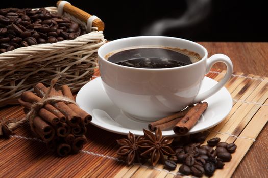 cup of coffee, spice and roasted beans in the basket