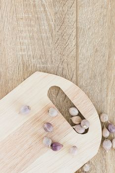 Top view Garlic on wood chopping board and wood table from above