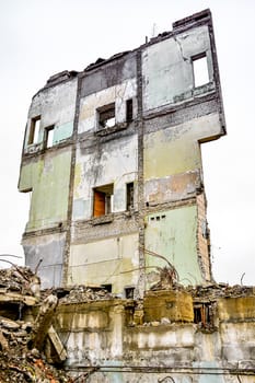Pieces of Metal and Stone are Crumbling from Demolished Building.
