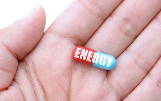 Close up of a hand holding an energy pill