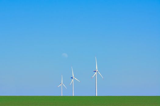 Three Wind Turbines in heat haze against of Blue Sky