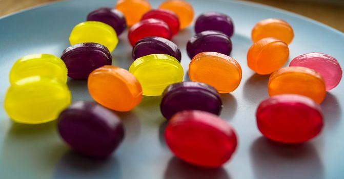 colored candy lollipops laid out on the plate