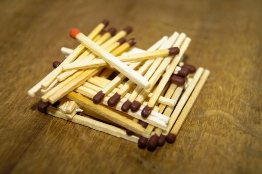 matches lined up in a pile on wooden background