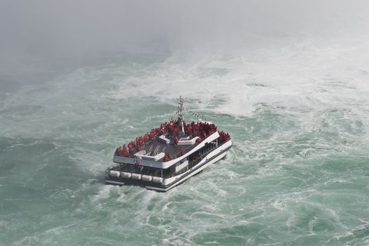 Beautiful isolated photo of a ship in the mist of the amazing Niagara falls