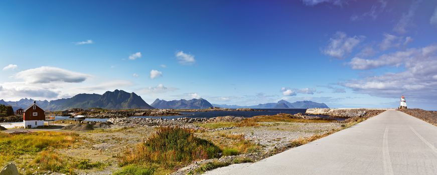 Norway landscape sunny summer panorama, fjord and mountains in the background. Beacon on a coast