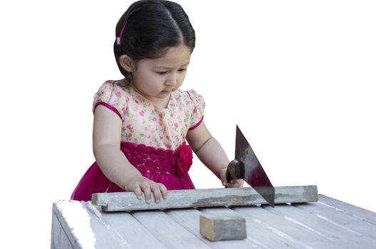 Little girl sawing plank with a handsaw. Isolated on white background.
