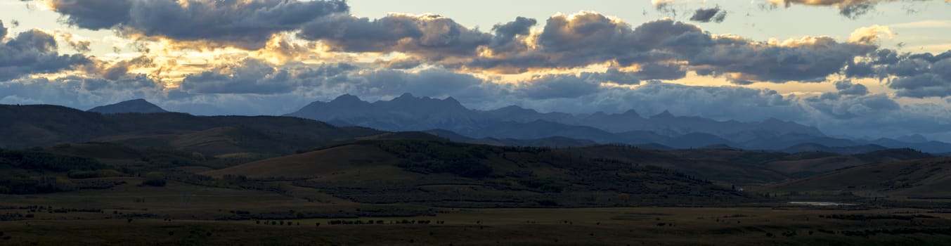 Orange sunset illuminating the mountains near the edge of the rockies