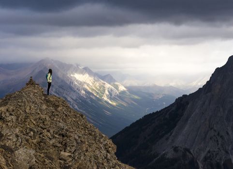 Female hiker looking at the view from top of mountain hike.