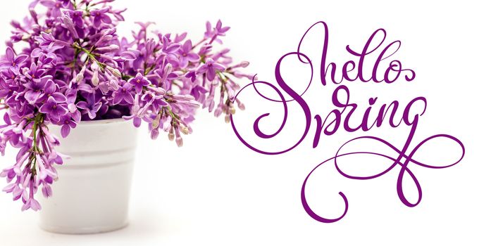 white bucket and lilac on a white background and text Hello Spring. Calligraphy lettering.