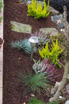 Small freshly made flowerbed in front of a house.