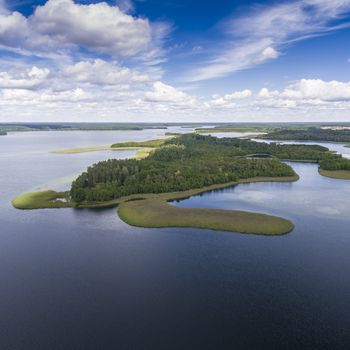 Lake Wigry National Park. Suwalszczyzna, Poland. Blue water and whites clouds. Summer time. View from above.
