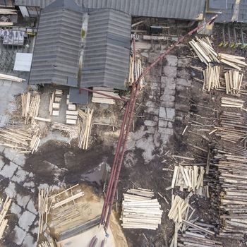 Sawmill. Felled trees, logs stacked in a pile. View from above. Industrial background.