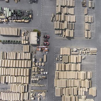 Industrial concrete drainage pipes stacked for construction. New tubes. Storage place. View from above.