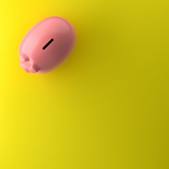 TOP VIEW OF PIGGY BANK ON YELLOW BACKGROUND