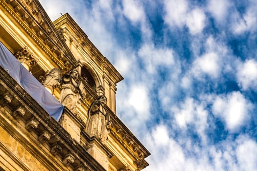 Detail of a italian baroque church on blue sky